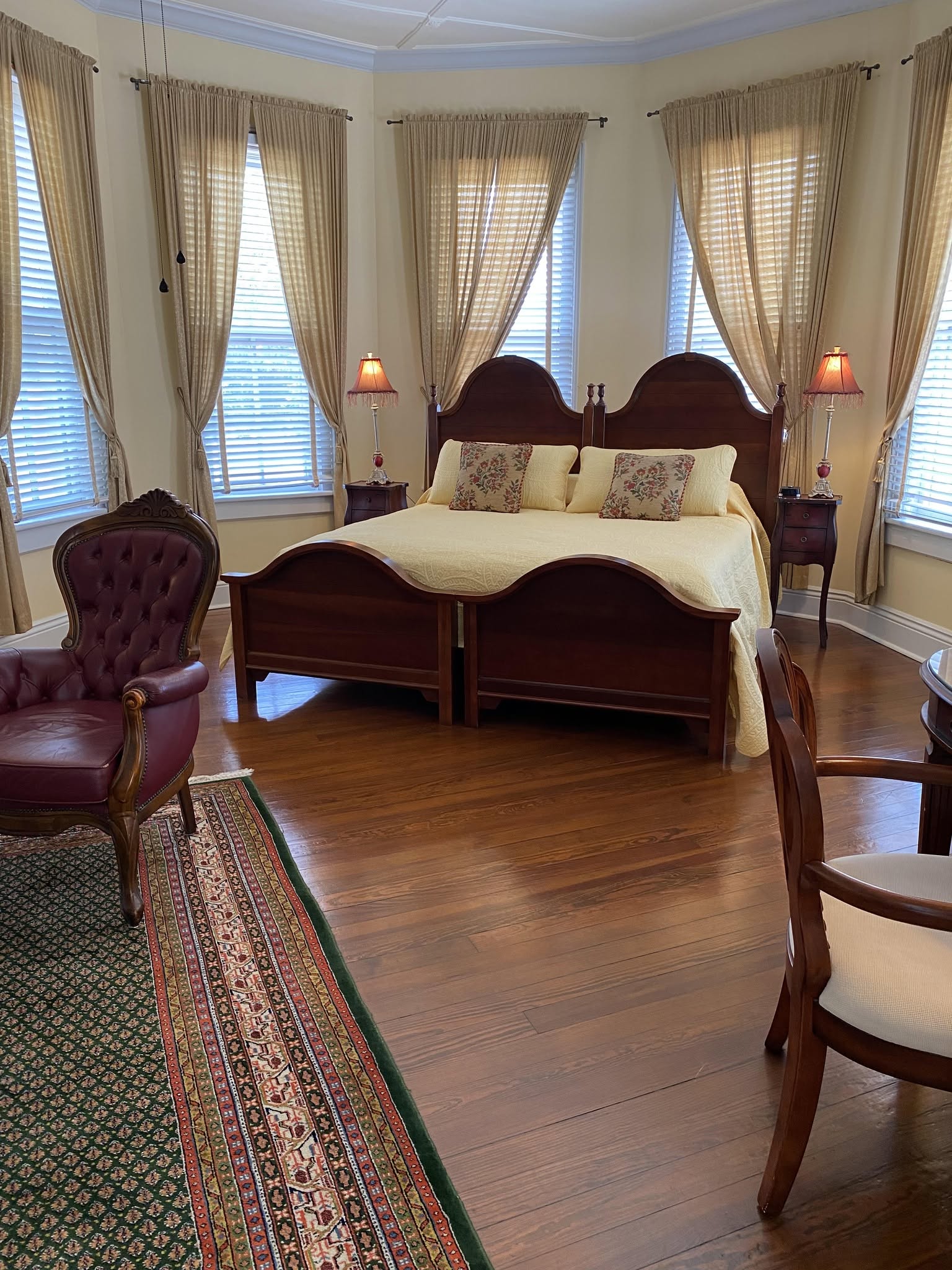 A guest room — pale-yellow linens in the bay-window light