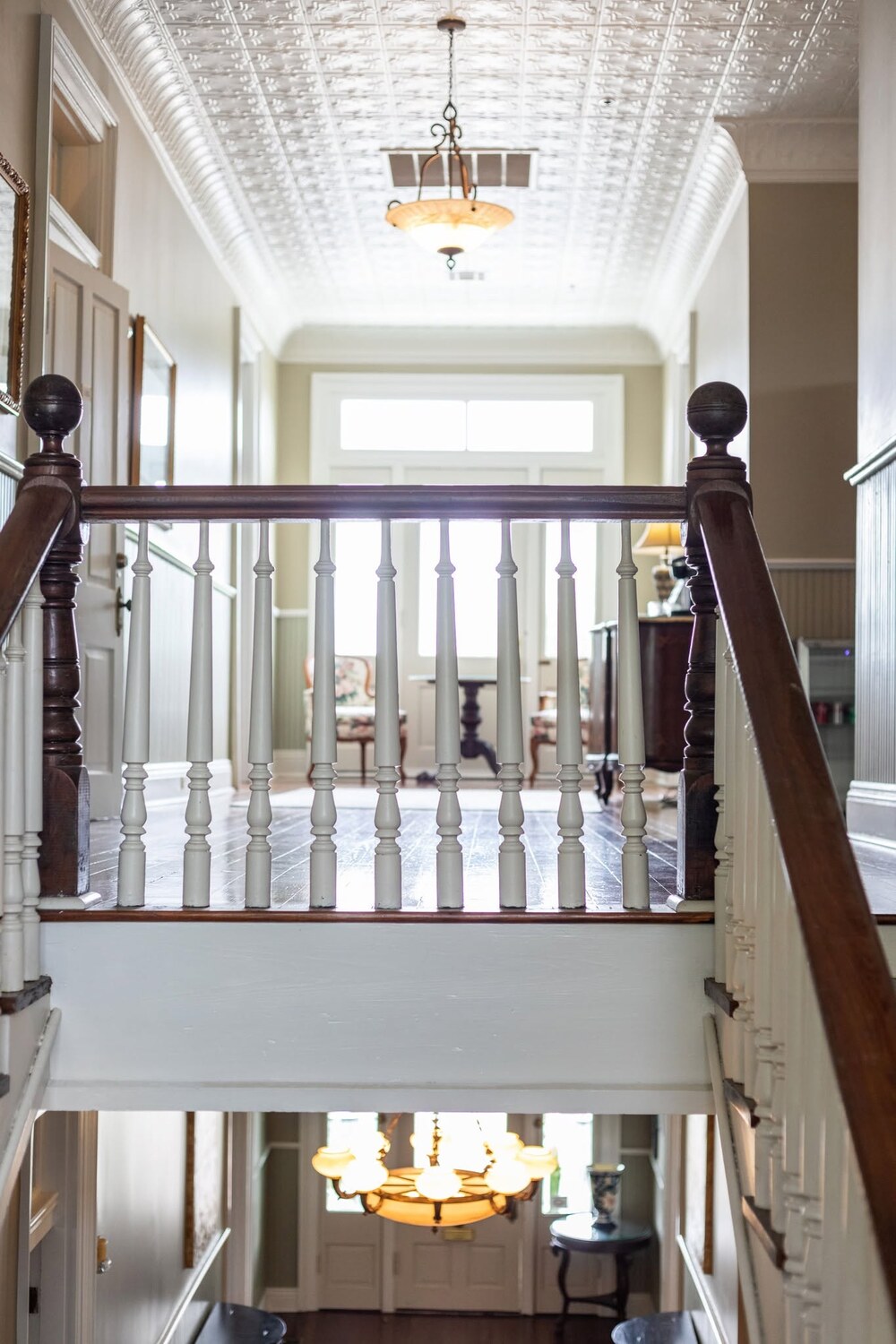 The Caldwell House's original staircase, pressed-tin ceiling, and transom-lit entry hall